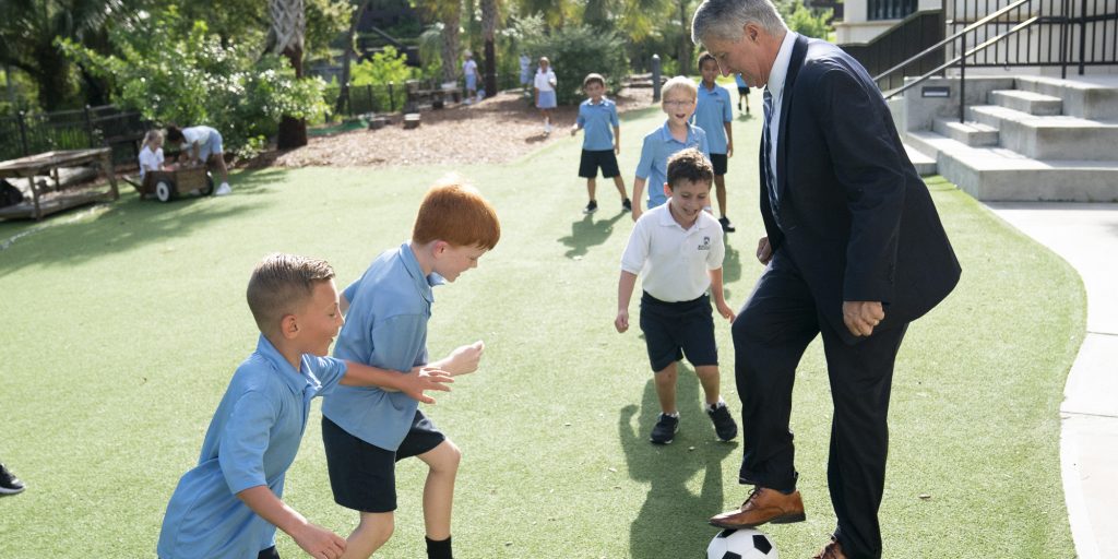 Headmaster Seivold playing soccer with Lower Division students